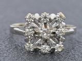 a close up of a diamond ring on a black surface