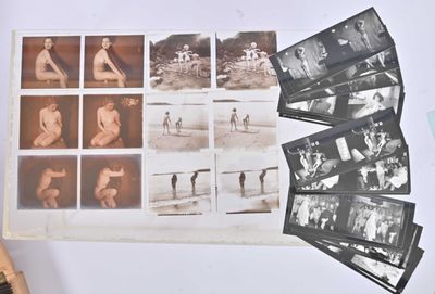 a lot of old black and white photos on the table