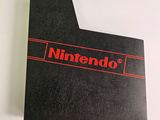 an image of a nintendo logo on top of a black book