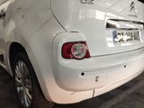 a small white car that is parked in a garage