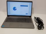 a laptop that is sitting on a table with a charger