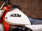 a close up of a motorcycle parked in front of a brick wall