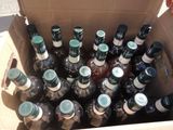 a cardboard box full of bottles of alcohol on the street