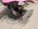 a pink hat sitting on top of a pink plow