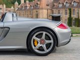 a silver sports car parked in front of a castle