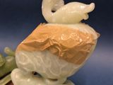 a figurine of a boy with a bird on his head
