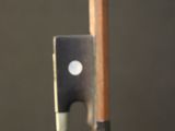 a violin bow and a bow rest on a table
