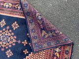 an image of a blue and red rug laying on the ground