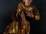 statue of a woman in a gold dress holding a book