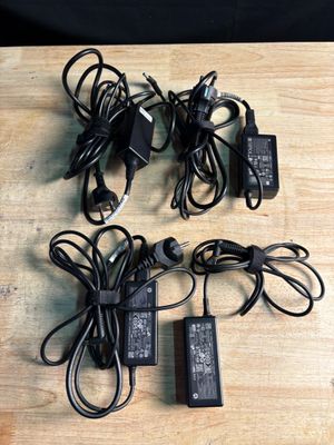four different types of power cords and a charger on a wooden surface