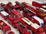 a lot of toy firetrucks that are on the table