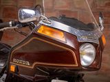 a motorcycle that is parked in front of a brick wall