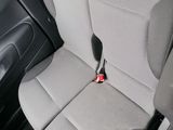 the back seats of a car with a cup holder in the center