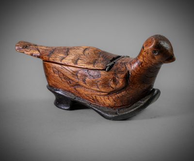 an old wooden bird sitting on top of a wooden box