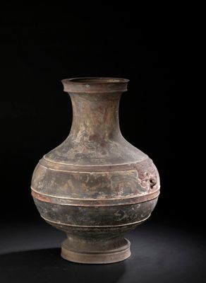 a vase that is sitting on a black surface