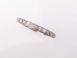 a white gold ring with diamonds on a white background
