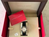 an open box with a watch inside of it on a marble surface