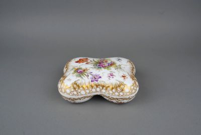 a close up of a small box with flowers on it