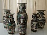 three vases sitting on a table with a curtain in the background