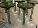 bottles and glasses are lined up on a tray in a kitchen