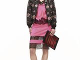 the woman is wearing a pink dress and black jacket