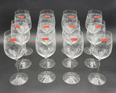 six empty wine glasses with red labels are lined up in a row