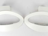 two pieces of white paper on a white surface