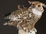 a figurine of an owl sitting on top of a table