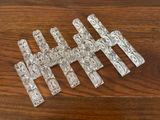 several pieces of clear glass sitting on top of a wooden table