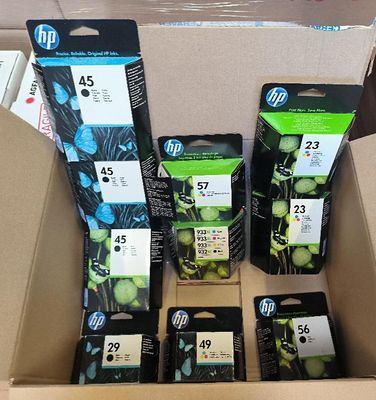 several packages of ink cartridges in a cardboard box on a table