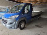 a blue truck that is parked in a garage