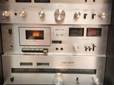 a radio and other electronics on display in a cabinet