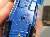 someone is holding a blue toy car in their hand