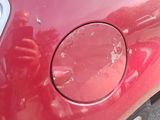 the car is red and has a dent in the front of it