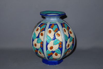 a blue vase with a design on it on a table