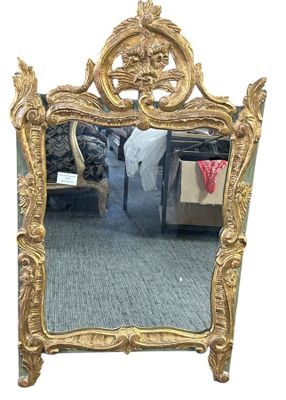 a mirror that is sitting on the floor in front of a bed