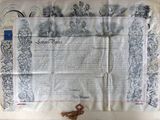 an old document with a tassel on top of it on a table