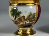 pair of vases with a painting of a country scene on them