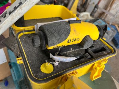 a yellow and black tool box with tools inside of it