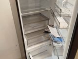 an open refrigerator that is sitting in the corner of a room