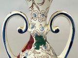 a vase with a floral design on it sitting on a table