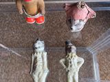 three plastic animals in a clear box on the floor