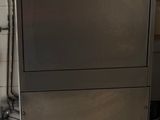 a stainless steel dishwasher in a kitchen next to a stove