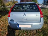 a small car that is parked in the grass