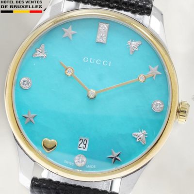 a close up of a wrist watch with a blue dial
