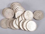 a pile of silver coins sitting on a white surface