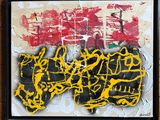 yellow and black graffiti on a piece of paper on a wooden surface