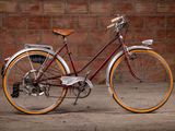 a bike that is parked in front of a brick wall