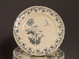 a stack of four plates with blue and white designs on them