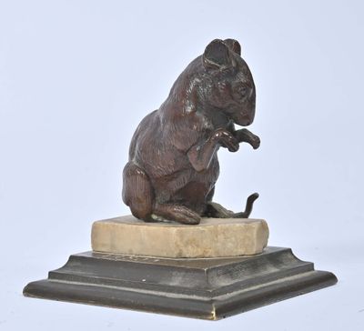 statue of a rat sitting on a marble base on a white background